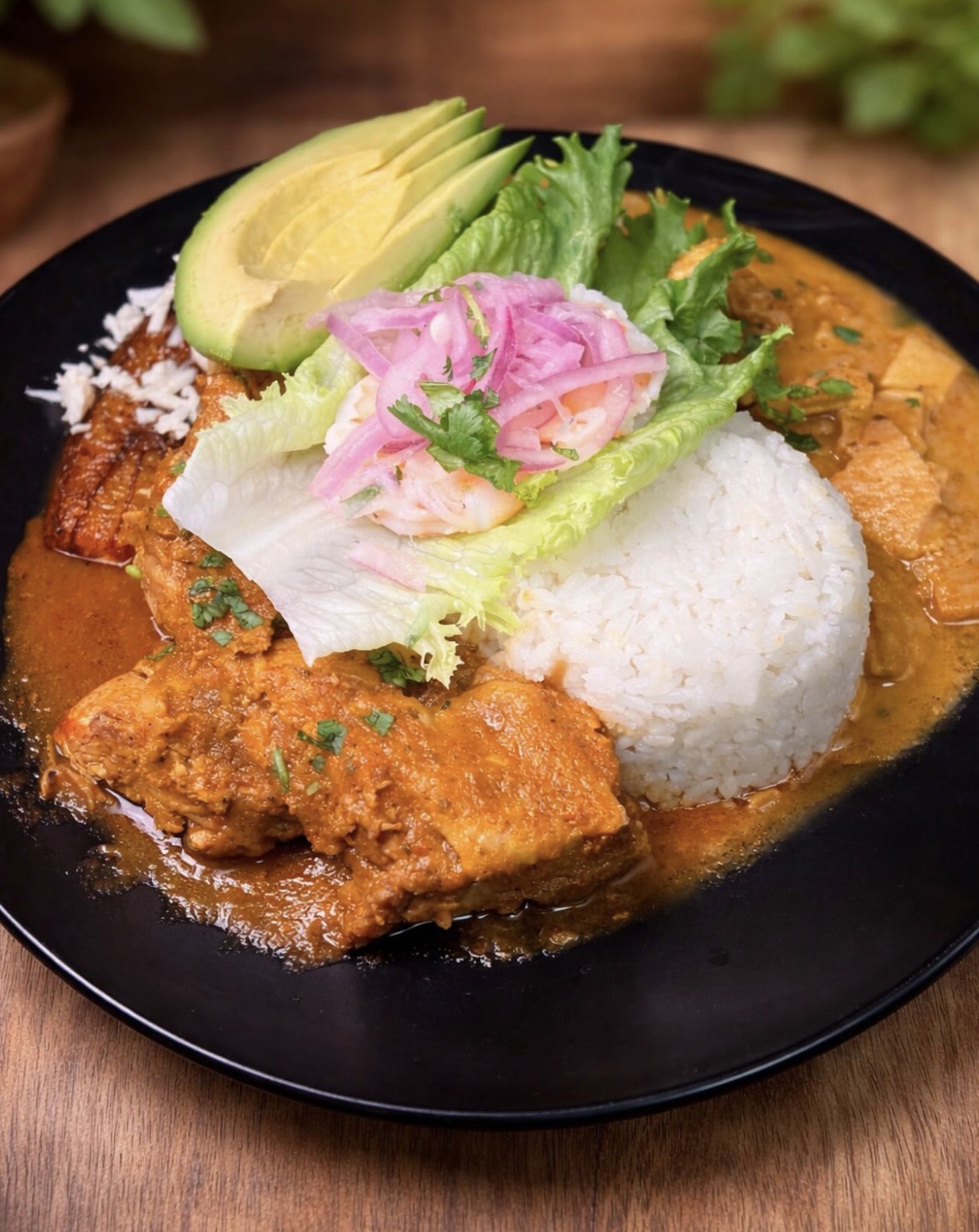 Seco de pollo plate with rice, avocado and plantain at Kasamia